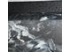 Close up of black and white marbled epoxy flooring in garage at 82 Cool Creek Dr, Willow Springs, NC 27592