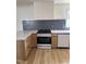 Modern kitchen features shaker cabinets, new appliances, and stylish backsplash at 82 Cool Creek Dr, Willow Springs, NC 27592