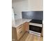 Modern kitchen features shaker cabinets, new appliances, and stylish backsplash at 82 Cool Creek Dr, Willow Springs, NC 27592