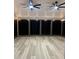 This airy sunroom porch has two fans and wood look floors at 82 Cool Creek Dr, Willow Springs, NC 27592