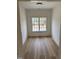 Bright room featuring wood flooring and a window providing natural light and neighborhood views at 82 Cool Creek Dr, Willow Springs, NC 27592