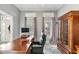 Elegant home office featuring a large desk, ample natural light, and a decorative cabinet at 82 Golf Dr, Sanford, NC 27332