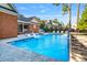 Private backyard featuring an in-ground pool with waterfall feature and elegant poolside furniture at 82 Golf Dr, Sanford, NC 27332