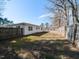 A spacious, fenced backyard with a grassy area and a view of the home's exterior at 823 Elmira Ave, Durham, NC 27707