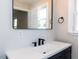 Modern bathroom features a sleek vanity with black hardware and a stylish mirror at 823 Elmira Ave, Durham, NC 27707