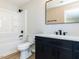 This bathroom features modern fixtures, a shower-tub combo, and dark vanity at 823 Elmira Ave, Durham, NC 27707
