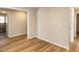 This bedroom features wood-look flooring, light walls, and neutral trim for a simple, clean aesthetic at 823 Elmira Ave, Durham, NC 27707