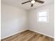 Bedroom with wood-look flooring, window, and neutral colors at 823 Elmira Ave, Durham, NC 27707