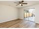 The bedroom features wood-look flooring and a glass door to a private patio with a partial fence and seating at 823 Elmira Ave, Durham, NC 27707