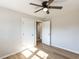 Bedroom with wood-look flooring, ceiling fan, and closet at 823 Elmira Ave, Durham, NC 27707