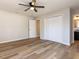 The bedroom offers hardwood floors, fresh paint, a ceiling fan, and a large double-door closet at 823 Elmira Ave, Durham, NC 27707
