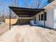 Exterior view showcasing a carport, a well-maintained yard, and part of home's facade at 823 Elmira Ave, Durham, NC 27707