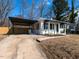 Attractive home exterior with a carport, well-kept lawn, and tasteful landscaping at 823 Elmira Ave, Durham, NC 27707