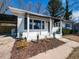 Up-close view of a home's inviting front porch and well-manicured landscaping at 823 Elmira Ave, Durham, NC 27707