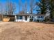 Charming single-story home with white siding, covered parking and neatly kept front yard at 823 Elmira Ave, Durham, NC 27707