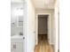Hallway features neutral paint, wood floors and access to updated bath at 823 Elmira Ave, Durham, NC 27707
