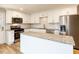 Modern kitchen with stainless steel appliances, granite countertops, and white cabinets at 823 Elmira Ave, Durham, NC 27707