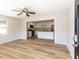 Clean living room that opens to the kitchen featuring modern appliances and hardwood flooring at 823 Elmira Ave, Durham, NC 27707