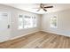 Bright, minimalist room featuring a ceiling fan, hardwood flooring, and white trim at 823 Elmira Ave, Durham, NC 27707