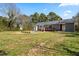 Large backyard featuring a patio, deck, and lush greenery surrounding the home at 8412 Pierce Olive Rd, Apex, NC 27539
