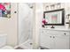 Modern bathroom featuring a walk-in shower with marble-style tile and a sleek vanity with framed mirror at 8412 Pierce Olive Rd, Apex, NC 27539