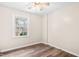 Neutral bedroom with a window offering natural light and wood-look flooring at 8412 Pierce Olive Rd, Apex, NC 27539