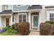 Inviting townhome with a green front door, tidy landscaping, and a cozy entrance at 917 Hamlet Park Dr, Morrisville, NC 27560