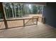 A wood porch with black railings overlooking a private wooded backyard at 9231 Bear Run Ln, Middlesex, NC 27557