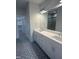 Modern bathroom with dual sink vanity, decorative tile floor, and glass shower door at 9231 Bear Run Ln, Middlesex, NC 27557