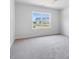 Bedroom features plush carpet, bright natural light, and a view of the neighborhood at 9231 Bear Run Ln, Middlesex, NC 27557