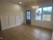Bright dining area with stylish light fixture and wood floors; view of the home's exterior and nearby greenery at 9231 Bear Run Ln, Middlesex, NC 27557