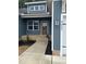 Inviting entryway with a brown front door, brick steps, fresh landscaping, and modern exterior lighting at 9231 Bear Run Ln, Middlesex, NC 27557