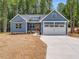 A beautiful one story home with a blue exterior and a two car garage at 9231 Bear Run Ln, Middlesex, NC 27557