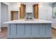 Stunning kitchen island with a white countertop and stylish blue cabinetry with stainless hardware at 9231 Bear Run Ln, Middlesex, NC 27557