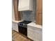 Close-up of the kitchen featuring stainless steel stove top, custom cabinets, countertops and modern backsplash at 9231 Bear Run Ln, Middlesex, NC 27557