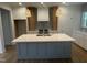 Bright and modern kitchen features a large island, custom cabinetry, and stainless-steel appliances at 9231 Bear Run Ln, Middlesex, NC 27557