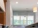 Modern kitchen featuring sleek white range hood, wood cabinets and gray tile backsplash at 9231 Bear Run Ln, Middlesex, NC 27557