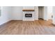 Living room with a modern fireplace and wooden floors at 9231 Bear Run Ln, Middlesex, NC 27557