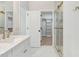 Bright bathroom featuring double sink vanity and walk in closet at 9235 Bear Run Ln, Middlesex, NC 27557