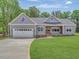 Charming single-story home with gray siding, manicured lawn, and an attached two car garage at 9235 Bear Run Ln, Middlesex, NC 27557