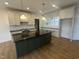 Kitchen showcasing a center island with sink, modern appliances, and sleek countertops at 9235 Bear Run Ln, Middlesex, NC 27557