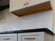 Close-up of white kitchen cabinets with granite countertops and tiled backsplash at 9235 Bear Run Ln, Middlesex, NC 27557