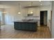 Kitchen features a center island, white cabinets, modern appliances, and stylish pendant lighting at 9235 Bear Run Ln, Middlesex, NC 27557