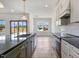 Well-lit kitchen with a gray kitchen island, stainless steel appliances, and adjacent dining area at 9235 Bear Run Ln, Middlesex, NC 27557