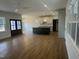 Open-concept kitchen featuring a center island, modern appliances, and hardwood floors at 9235 Bear Run Ln, Middlesex, NC 27557