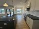 Bright kitchen with dark island, stainless steel appliances, granite counters, and eat-in dining area at 9235 Bear Run Ln, Middlesex, NC 27557