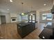 Open-concept kitchen with large island, stainless appliances, and hardwood floors, connecting to the living area at 9235 Bear Run Ln, Middlesex, NC 27557