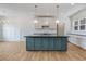 Bright kitchen featuring a large island, stainless steel appliances, and modern pendant lighting at 9235 Bear Run Ln, Middlesex, NC 27557