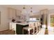 Rendering of a kitchen with white marble countertops, an island with seating, and stainless steel appliances at 9235 Bear Run Ln, Middlesex, NC 27557