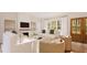Rendering of living room with fireplace, neutral decor, and view of the outdoor scenery at 9235 Bear Run Ln, Middlesex, NC 27557